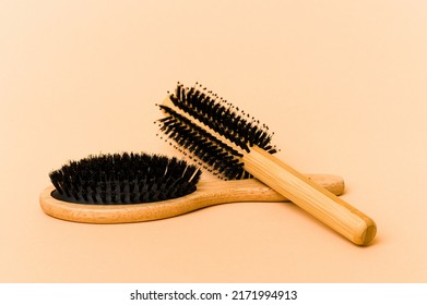 Two types of hairbrush isolated on beige background