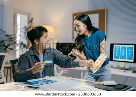 Two ui developers are having a discussion about a mobile application interface, exchanging ideas and suggestions for the project