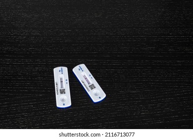 Two UK Negative NHS Test And Trace Lateral Flow Covid Tests On A Black Table With Of Copy Space