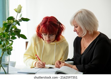 Two Ukrainian Refugees Women Sits At Table. Mother With Daughter Preparing For The University Entrance Exam In Europe