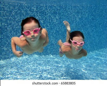 Two Underwater Kids In Swimming Pool