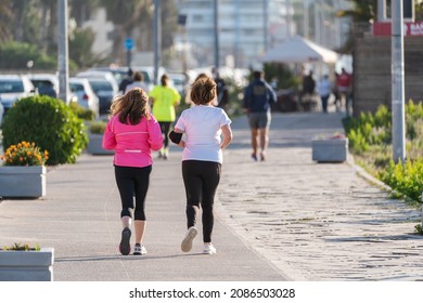 Two Unknown Senior Or Mature Women Running On The Street