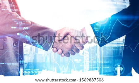 Two unrecognizable businessmen shaking hands in city with double exposure of big data interface. Concept of partnership and hi tech startup. Toned image