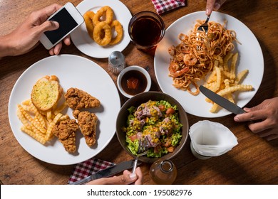 Two Unrecognizable People Eating Together, View From The Top