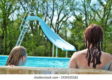 Two Unrecognizable Teen Girls Hanging Out Talking In The Pool