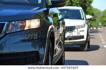 Two vehicles in motion at the suburban road stock photo
