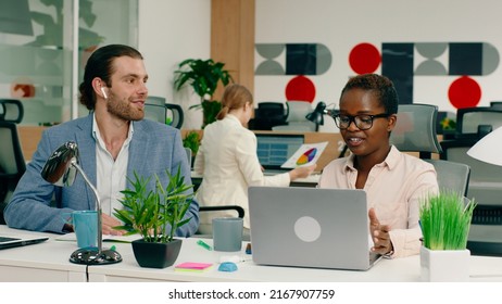 Two Very Attractive Workers Are In A Deep Conversation At Their Work Desks In A Very Brightly Lit Office, Their Manager Approaches Them