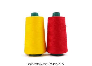 Two vibrant spools of thread, one bright yellow and one vivid red, stand upright against a clean white background.