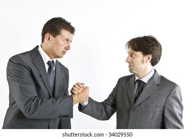 two  victorious businessmen shacking hands