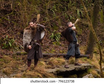 Two Vikings Play The Horn In The Forest