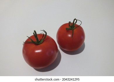 Two vine tomatoes isolated in white background