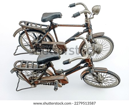 Two vintage bicycles, unique brown vintage miniature bicycles on a white isolate background