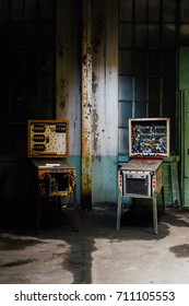 Two Vintage But Broken Pinball Machines Were Left Behind At A Break Room Inside An Abandoned Clothing Factory.