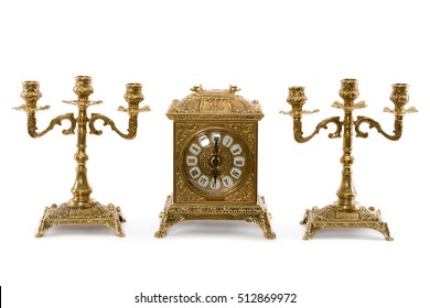 Two Vintage Gold Candle Holder And Clock On A White Background