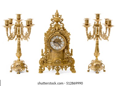 Two vintage gold candle holder and clock on a white background - Powered by Shutterstock