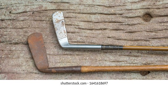 Two Vintage Golf Clubs With Hickory Shafts Isolated