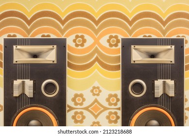 Two vintage stereo speakers in front of retro seventies flower wallpaper - Shutterstock ID 2123218688