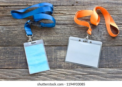 Two Vip Id Cards With Tags On Wooden Background