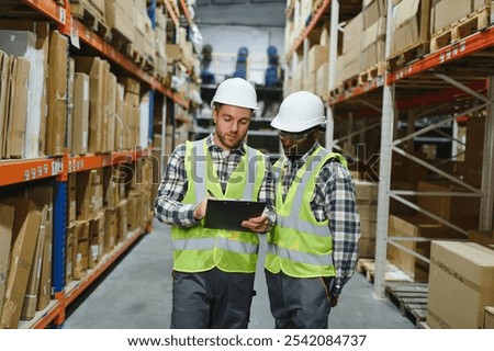 Two warehouse workers checking and controlling boxes in warehouse, Professional warehouse workers moving cardboard boxes by forklift stacker loader, Logistic and business export concept