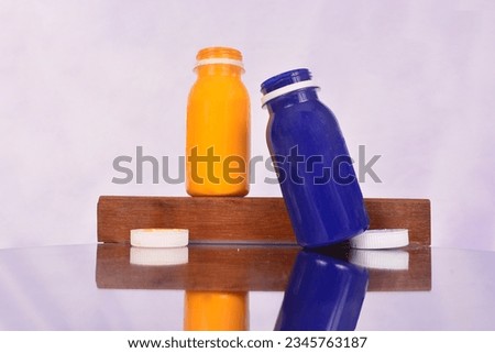 two watercolors blue with yellow with open lids