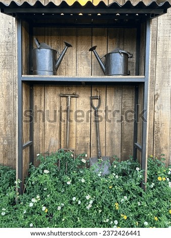 Two watering cans, a hoe, and a field fork as a decoration. [[stock_photo]] © 
