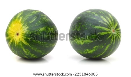 Two watermelons with a leaves on a white background.