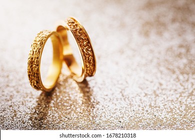 Two wedding rings on a brilliant background with a copy of space