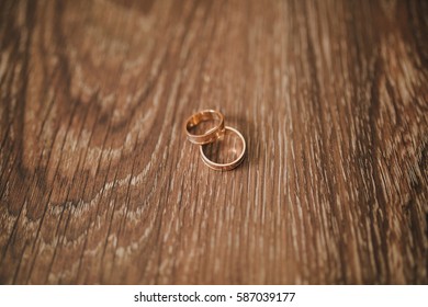 Two Wedding Rings On Wood Background