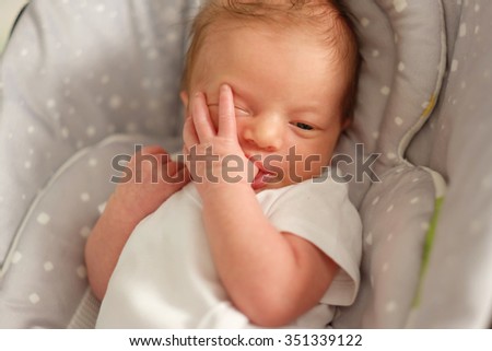 Image, Stock Photo Baby lies on a blanket and covers his eyes with his hands