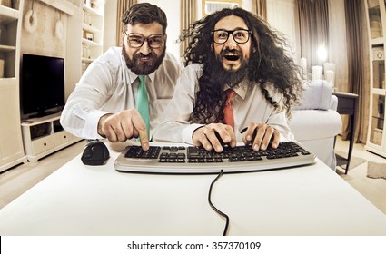 Two weird computer geeks having fun on computer