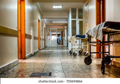 two wheelchairs stay along social hospital corridor. Wheelchair wait for visitors and ill people in corridor of city hospital. Social hospital for poor man. Interior of old city municipal hospital. - Powered by Shutterstock