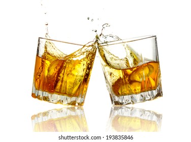 Two Whiskey Glasses Clinking Together, Isolated On White.