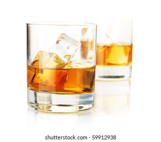 Two Whiskey Glasses. Isolated On White With Reflection