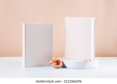 Two White Book Mockup On A Beige Table.