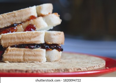 Two White Bread Stacked Peanut Butter And Jelly Dessert Sandwiches On A Plate Prepared At Home Kitchen Counter For Kids Sweet Unhealthy Diet Brown Bag School Lunch With Crust