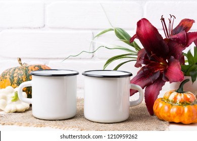 Two White Campfire Enamel Coffee Mug Mockup With Orange Pumpkin And Red Lily.  Empty Mug Mock Up For Design Promotion.  