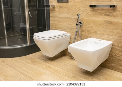 two white ceramic toilets (bidet) close up view