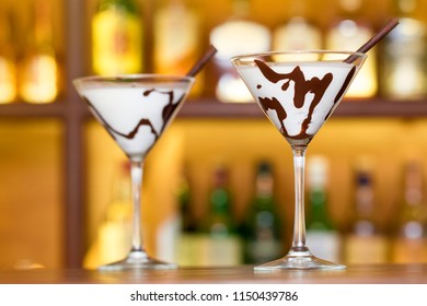 Two White Chocolate Martini Glass Garnish With A Stick On Bar