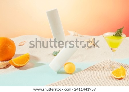 Two white cosmetic tubes are displayed on a white sand background with sea shells and fresh oranges, next to a cocktail glass. Cosmetic mockup for advertising.