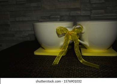 Two White Cups Tied In Place Against The Backdrop Of Decorative Stone, With Black Tea, Kava. Direct Sunlight