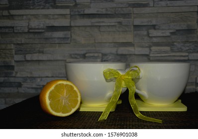 Two White Cups Tied In Place Against The Backdrop Of Decorative Stone, With Black Tea, Kava. Direct Sunlight