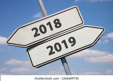 two white direction signs with arrows and the numbers 2018 and 2019, concept for turn of the year