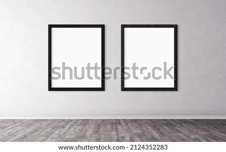 Two white empty posters with black wooden frame on wall.