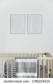 Two White Empty Wall Frames Above Infant Baby Cot Bed