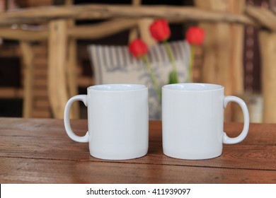 Two White Mug With Fireplace Behind It For Mockup