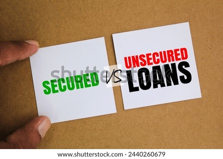 two white papers with the words Secured vs Unsecured Loan. Business loan concept