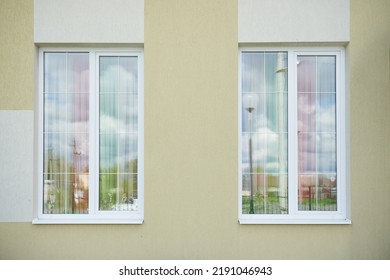 Two white plastic high windows with partitions