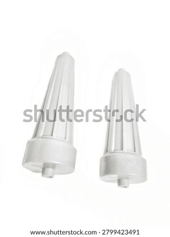 Two white plastic pulsator rollers for washing machine, side roller agitator parts, washing machine spare parts isolated on white background, Pair of white plastic side pulsator rollers for automatic washing machine. Agitator part, washing machine component, spare part for repair. Isolated on white background, macro product photography, vertical orientation.
