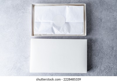 Two white square gift boxes mockup on gray concrete background. From above, top view, minimalist concept