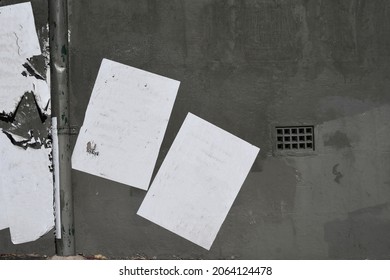 Two White Street Paste Up Poster Plastered Glued To A Grey Urban Concrete Wall 